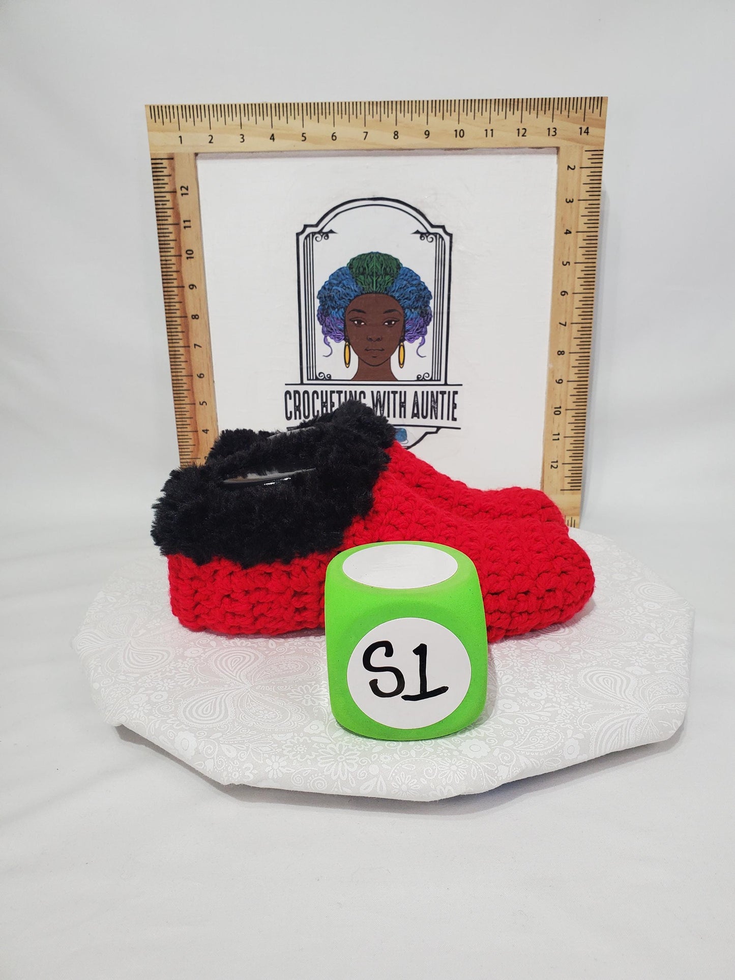 Item S1: Red slippers with black fur, made with 100% acrylic chunky yarn, Women's size 9/10