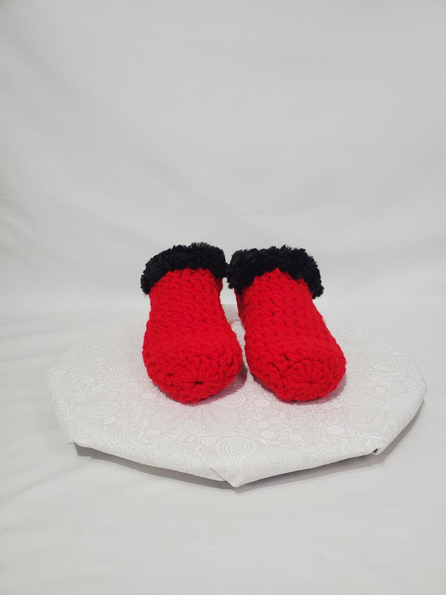Item S1: Red slippers with black fur, made with 100% acrylic chunky yarn, Women's size 9/10