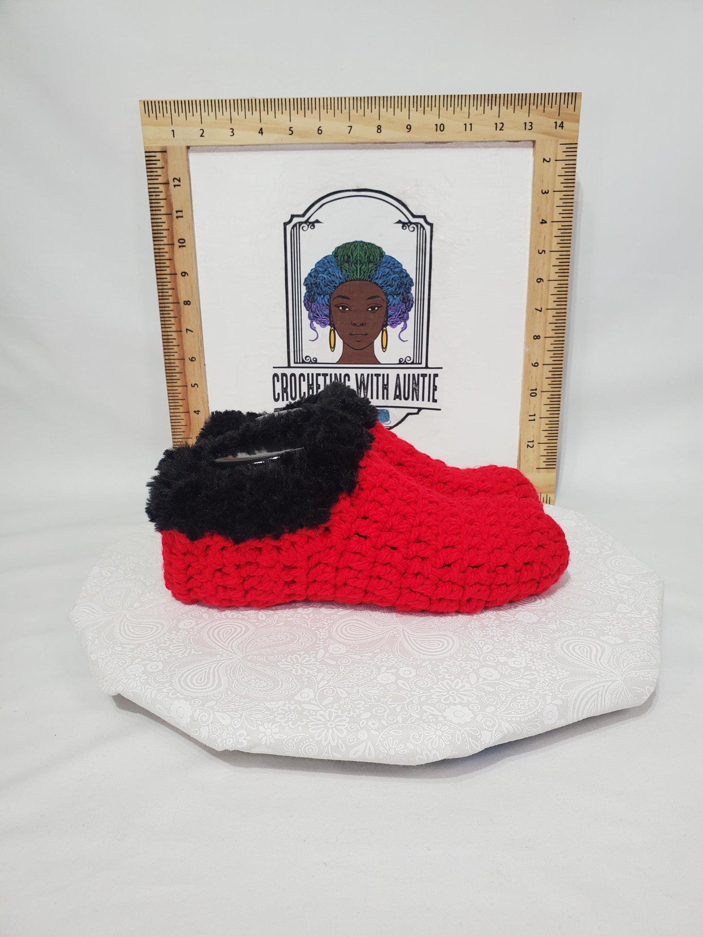 Item S1: Red slippers with black fur, made with 100% acrylic chunky yarn, Women's size 9/10