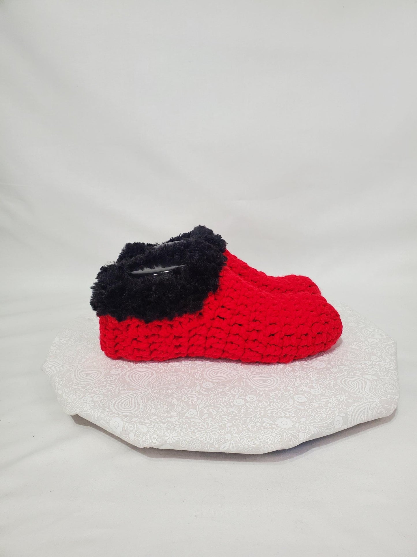 Item S1: Red slippers with black fur, made with 100% acrylic chunky yarn, Women's size 9/10