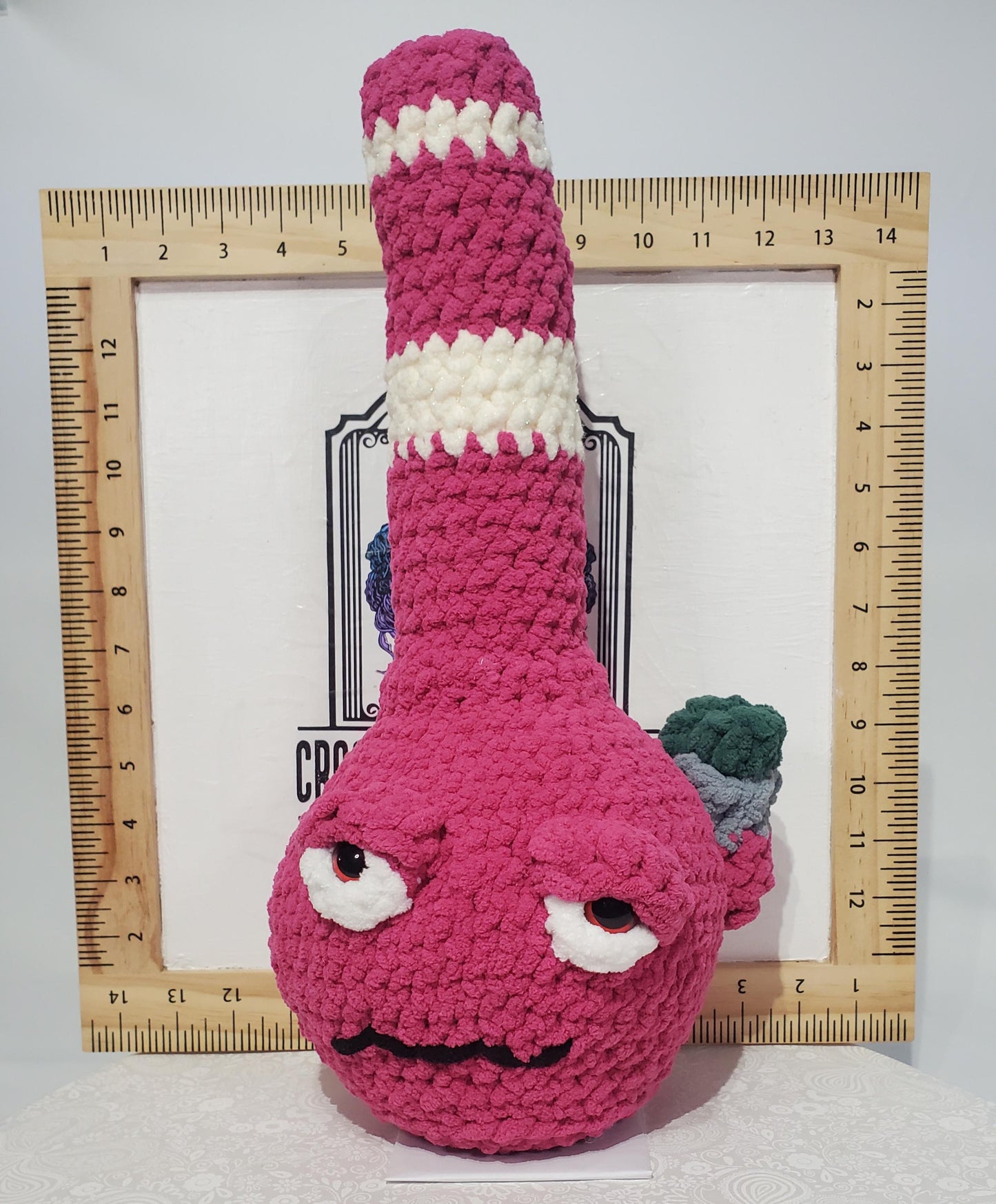 B8: Crochet Bong, Pink and white, made with 100% polyester, soft blanket yarn, and safety eyes, approx. 16" x 7", 13 oz