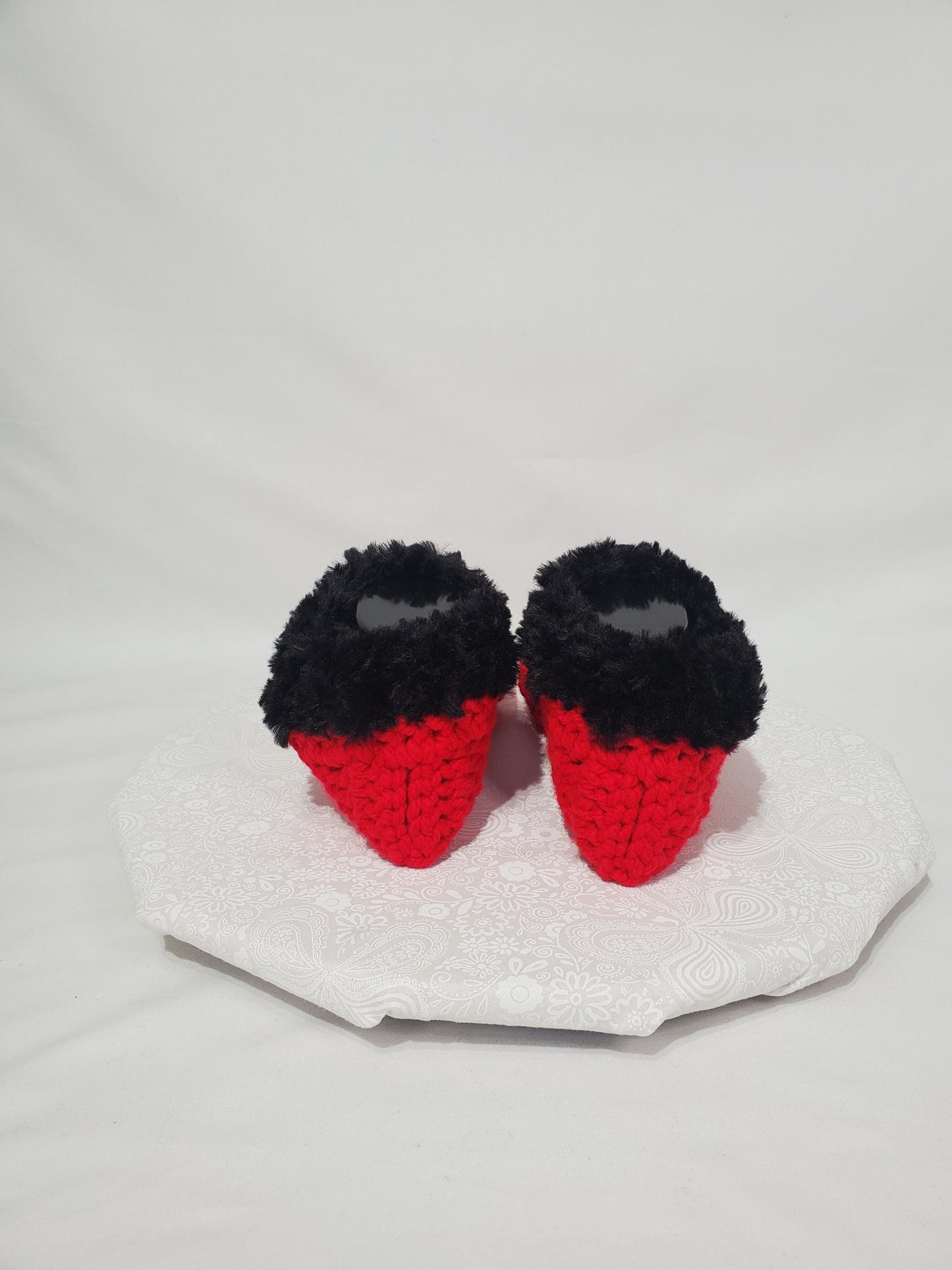 Item S1: Red slippers with black fur, made with 100% acrylic chunky yarn, Women's size 9/10