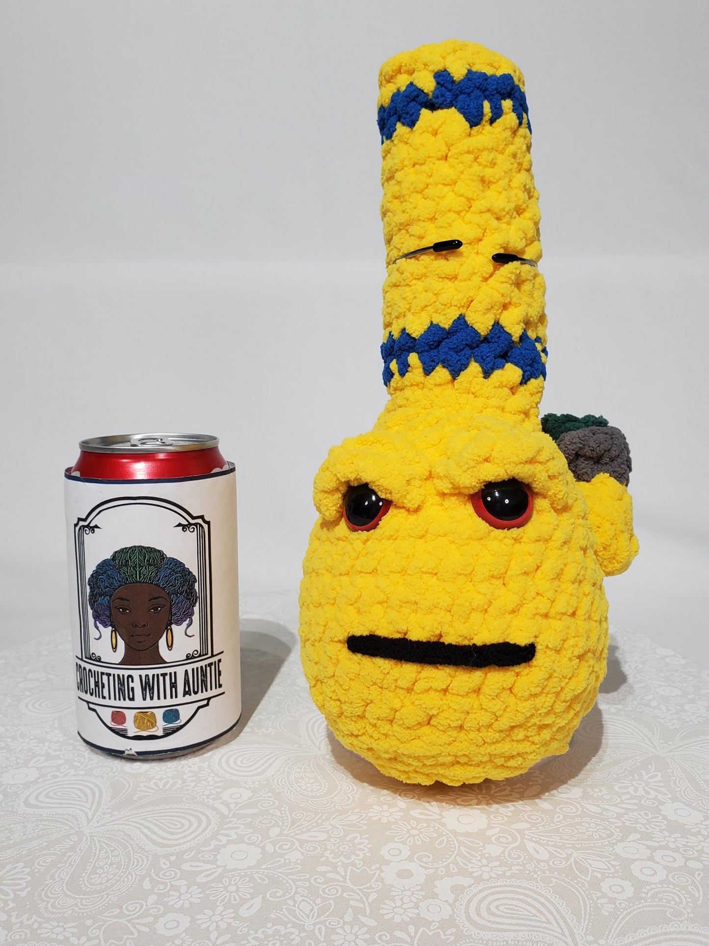 B3: Crochet Bong, yellow and blue, made with 100% polyester, soft blanket yarn, has safety eyes, 10" x 4", 5 oz