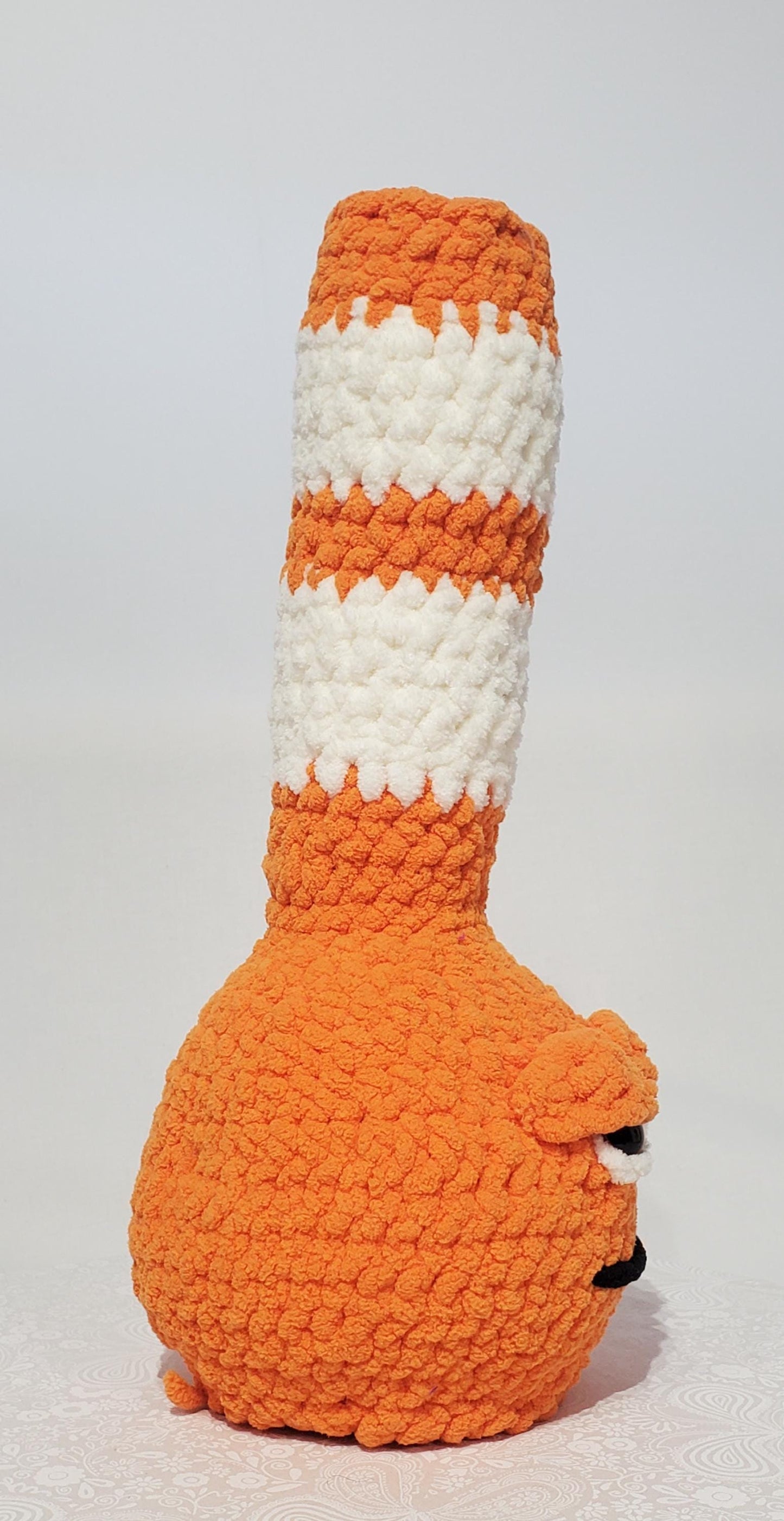 B5: Crochet Bong, Orange and White, made with 100% polyester, soft blanket yarn, has safety eyes, 15" x 6", 9 oz