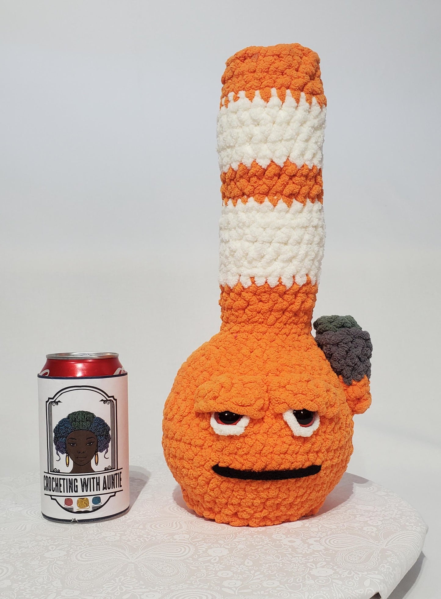 B5: Crochet Bong, Orange and White, made with 100% polyester, soft blanket yarn, has safety eyes, 15" x 6", 9 oz