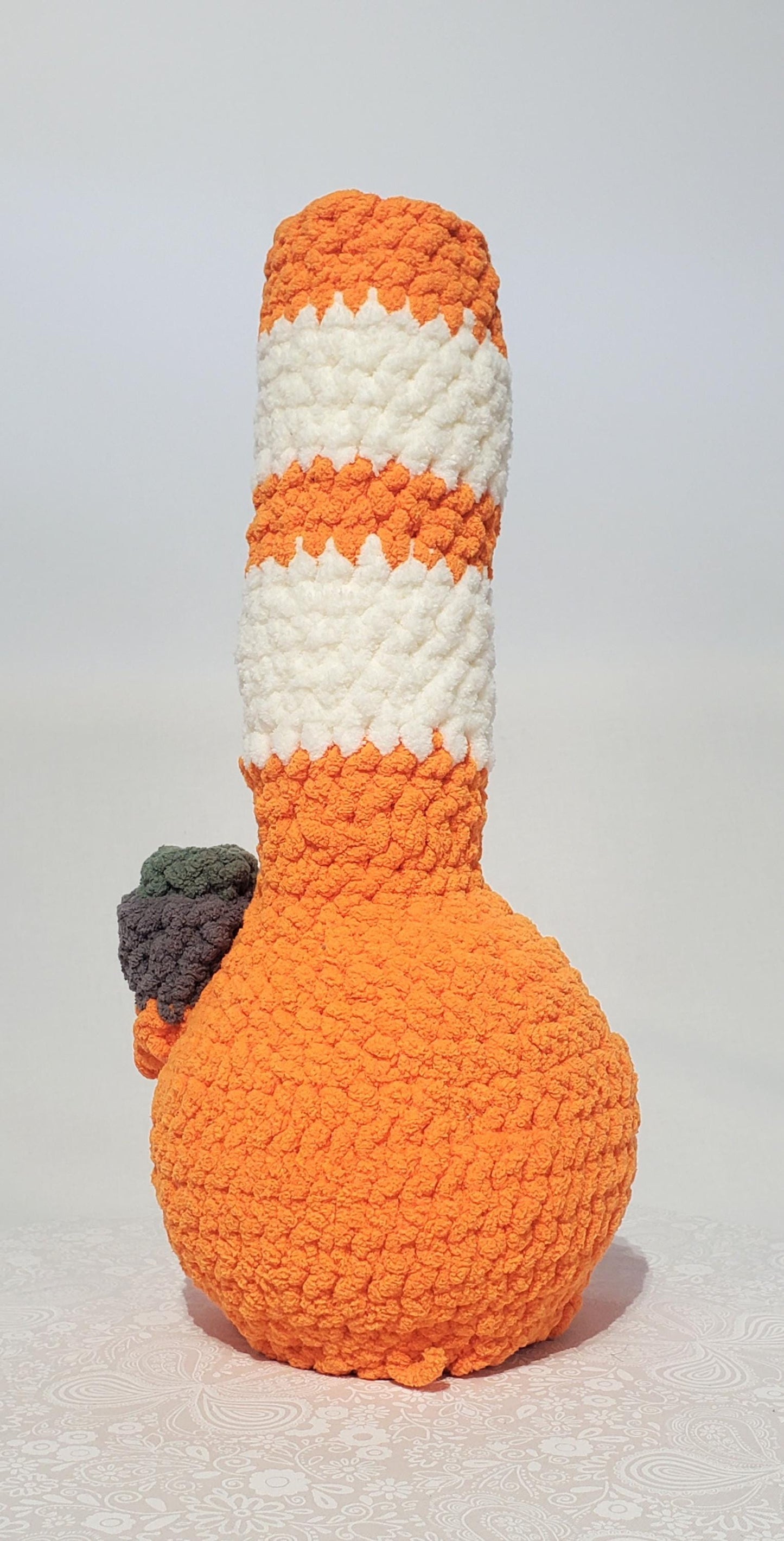 B5: Crochet Bong, Orange and White, made with 100% polyester, soft blanket yarn, has safety eyes, 15" x 6", 9 oz