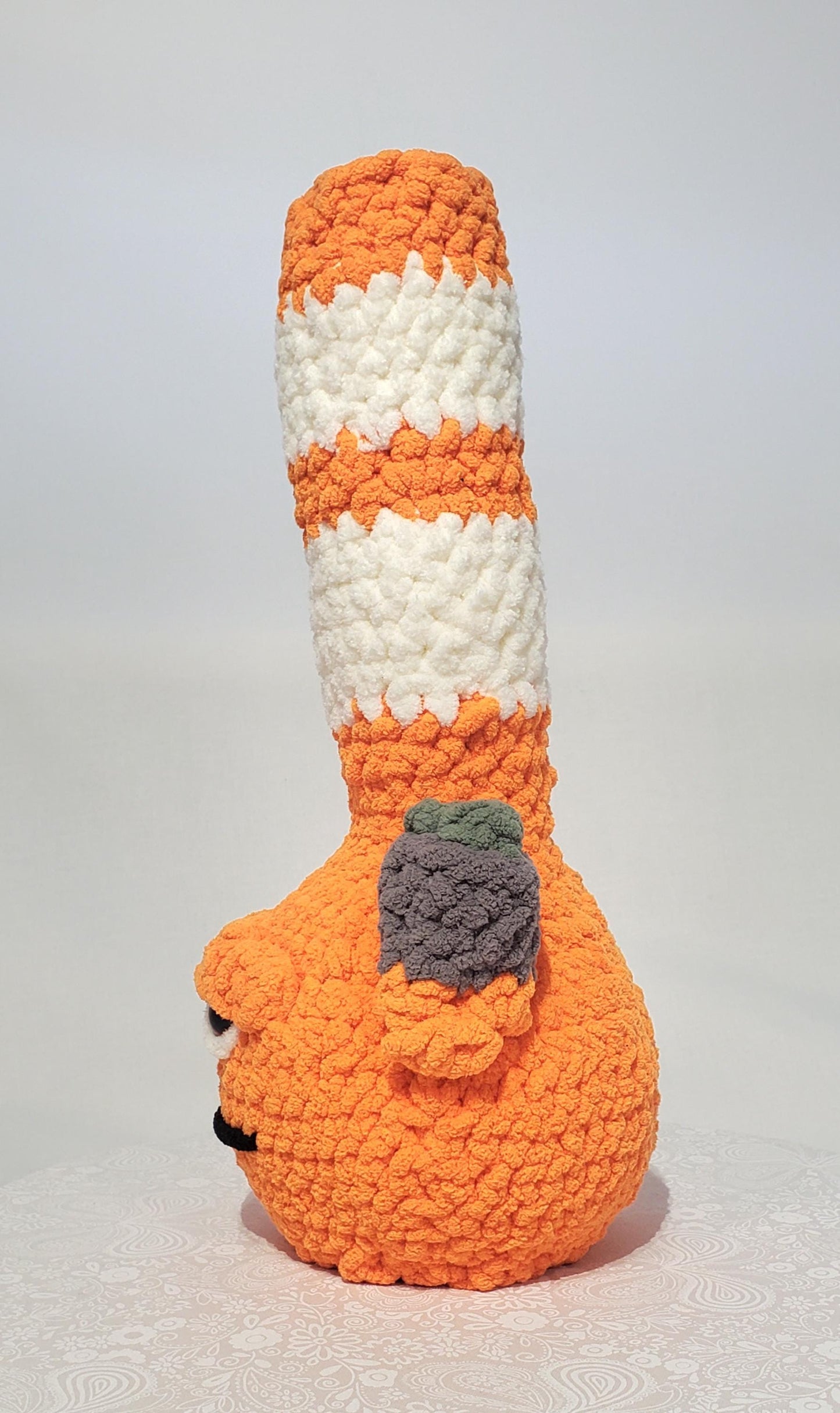 B5: Crochet Bong, Orange and White, made with 100% polyester, soft blanket yarn, has safety eyes, 15" x 6", 9 oz