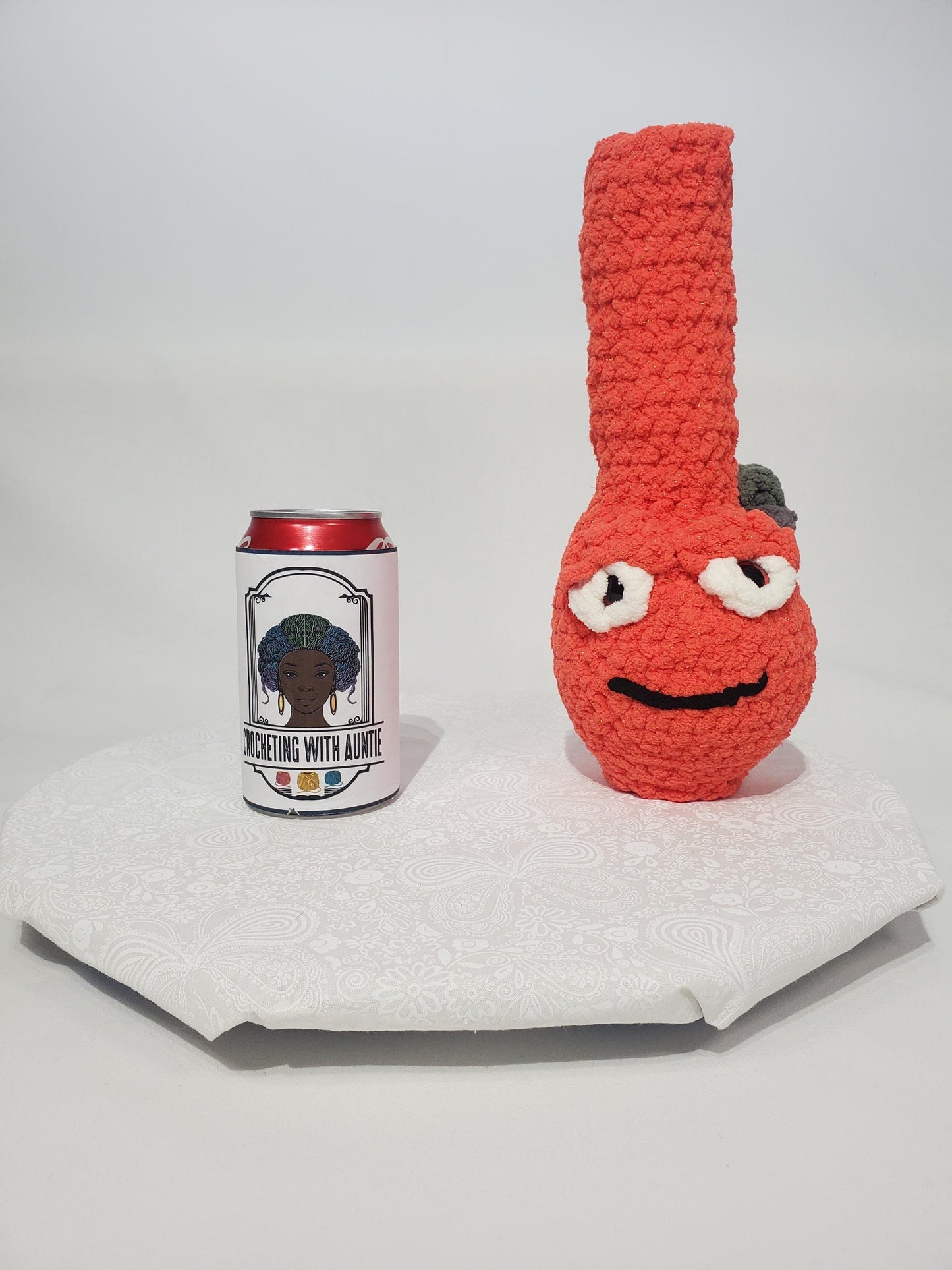 B14: Crochet Bong, Orange, made with 100% polyester, soft blanket yarn, and safety eyes, approx. 11" x 4", 6 oz