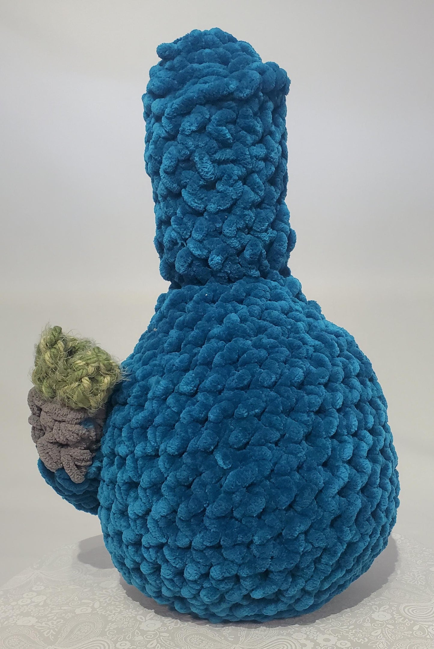 B18: Crochet Bong, Teal, made with 100% polyester soft blanket yarn and safety eyes, approx. 17" x 10", 1 lb 5 oz