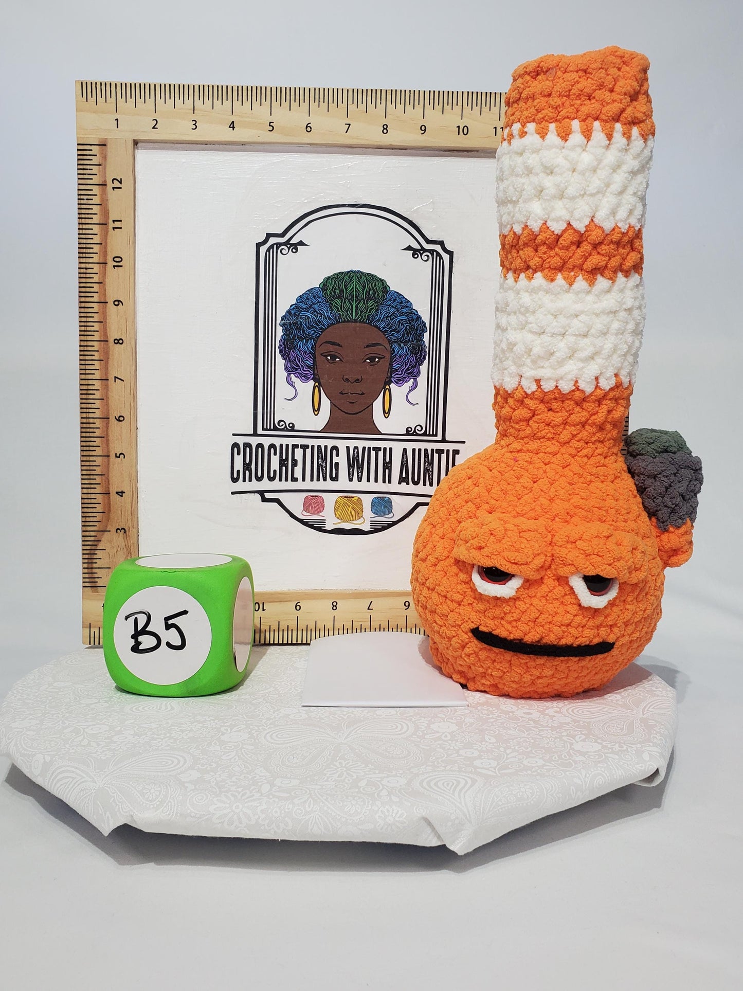 B5: Crochet Bong, Orange and White, made with 100% polyester, soft blanket yarn, has safety eyes, 15" x 6", 9 oz