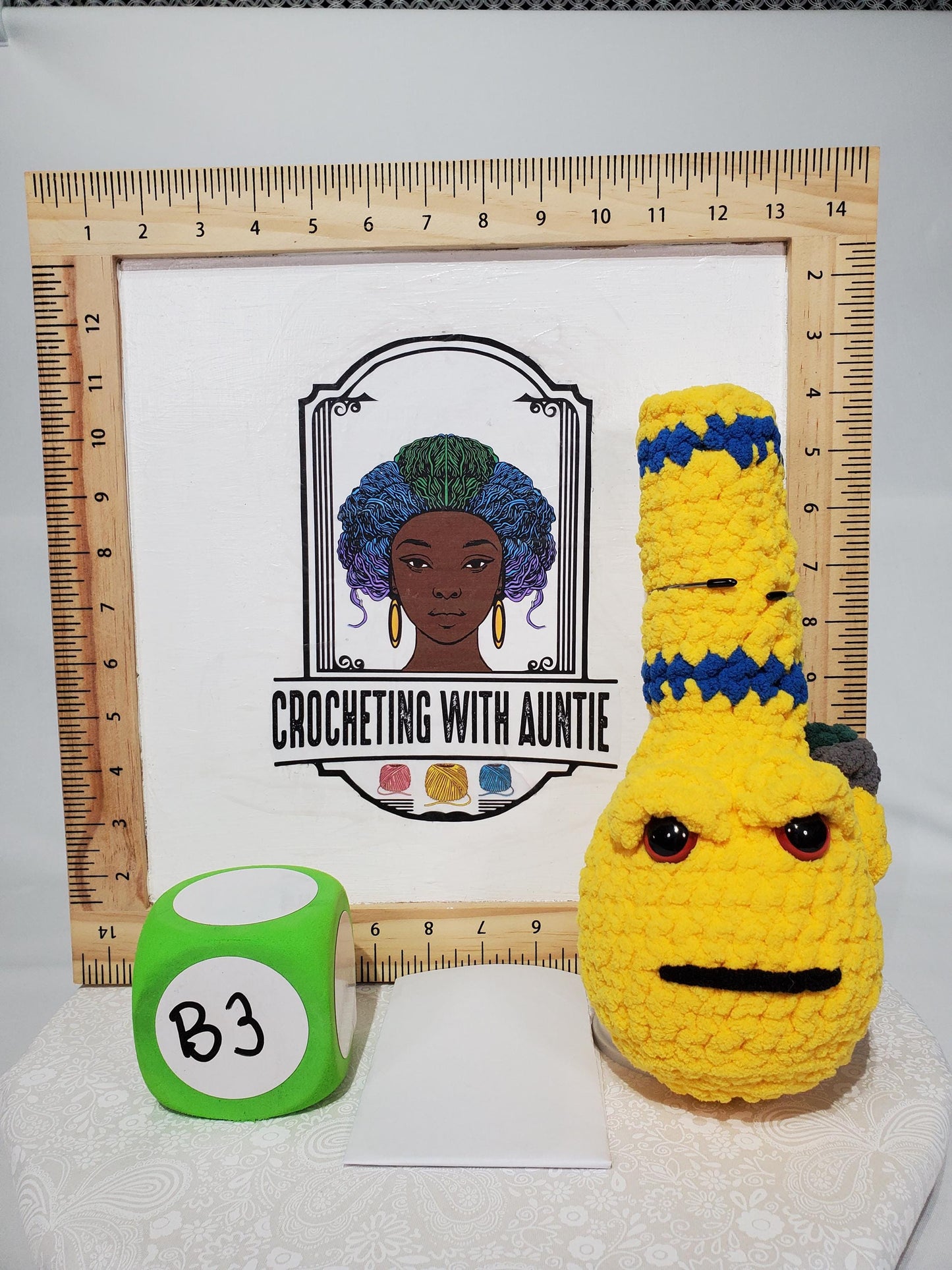 B3: Crochet Bong, yellow and blue, made with 100% polyester, soft blanket yarn, has safety eyes, 10" x 4", 5 oz