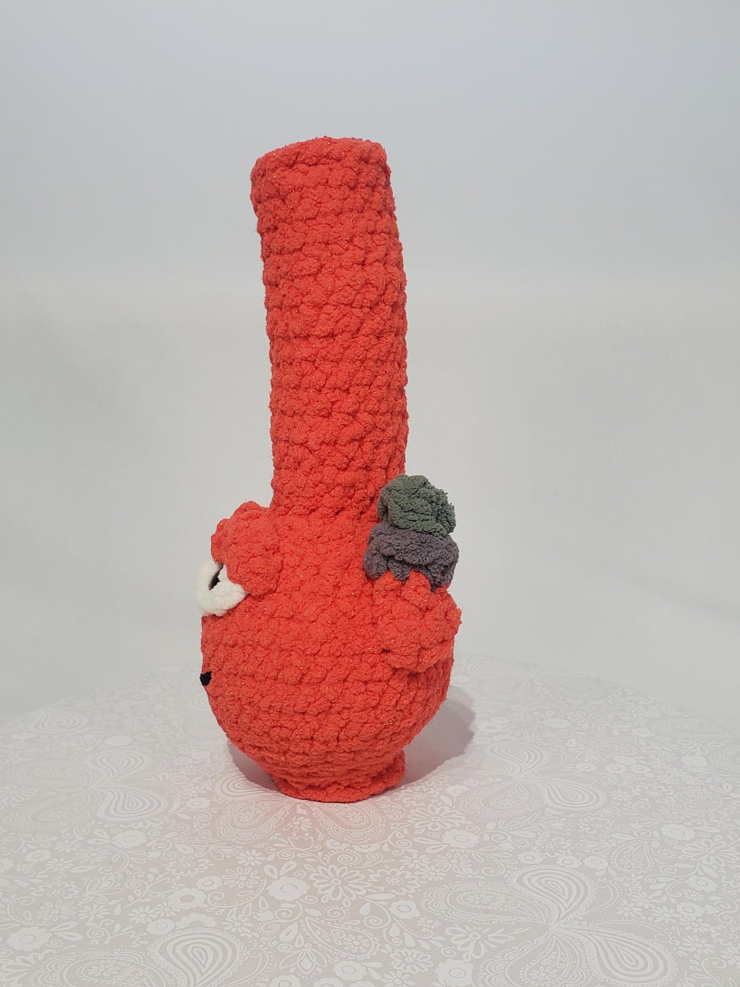 B14: Crochet Bong, Orange, made with 100% polyester, soft blanket yarn, and safety eyes, approx. 11" x 4", 6 oz