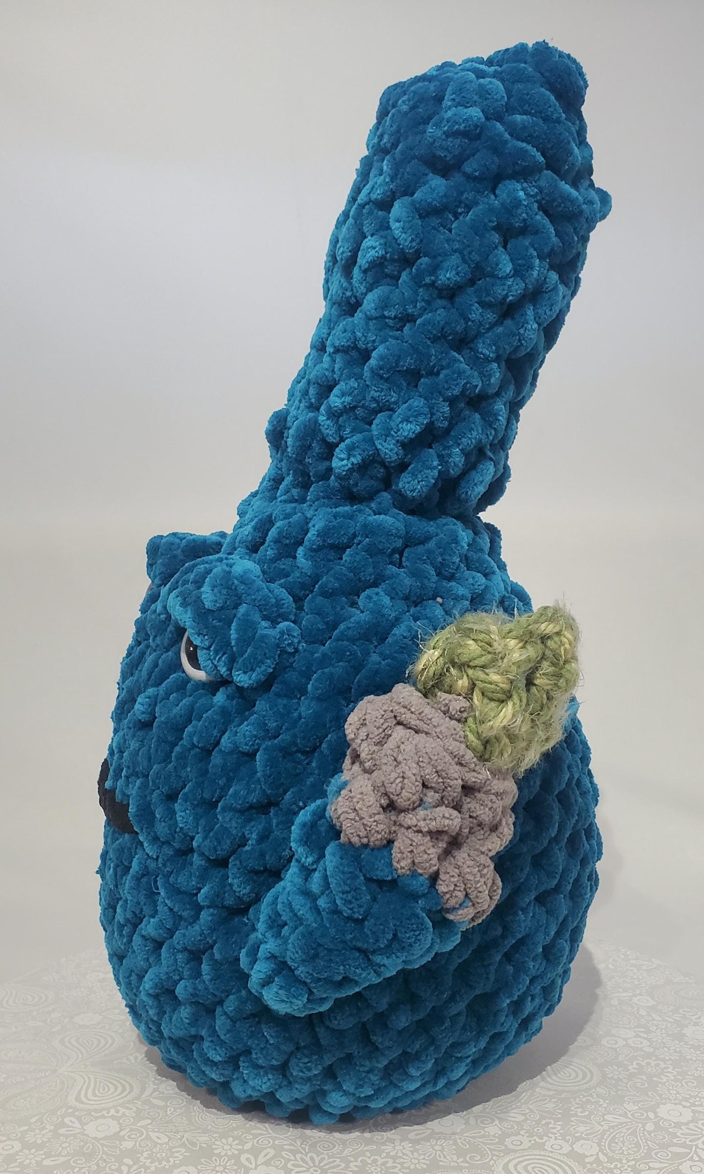 B18: Crochet Bong, Teal, made with 100% polyester soft blanket yarn and safety eyes, approx. 17" x 10", 1 lb 5 oz