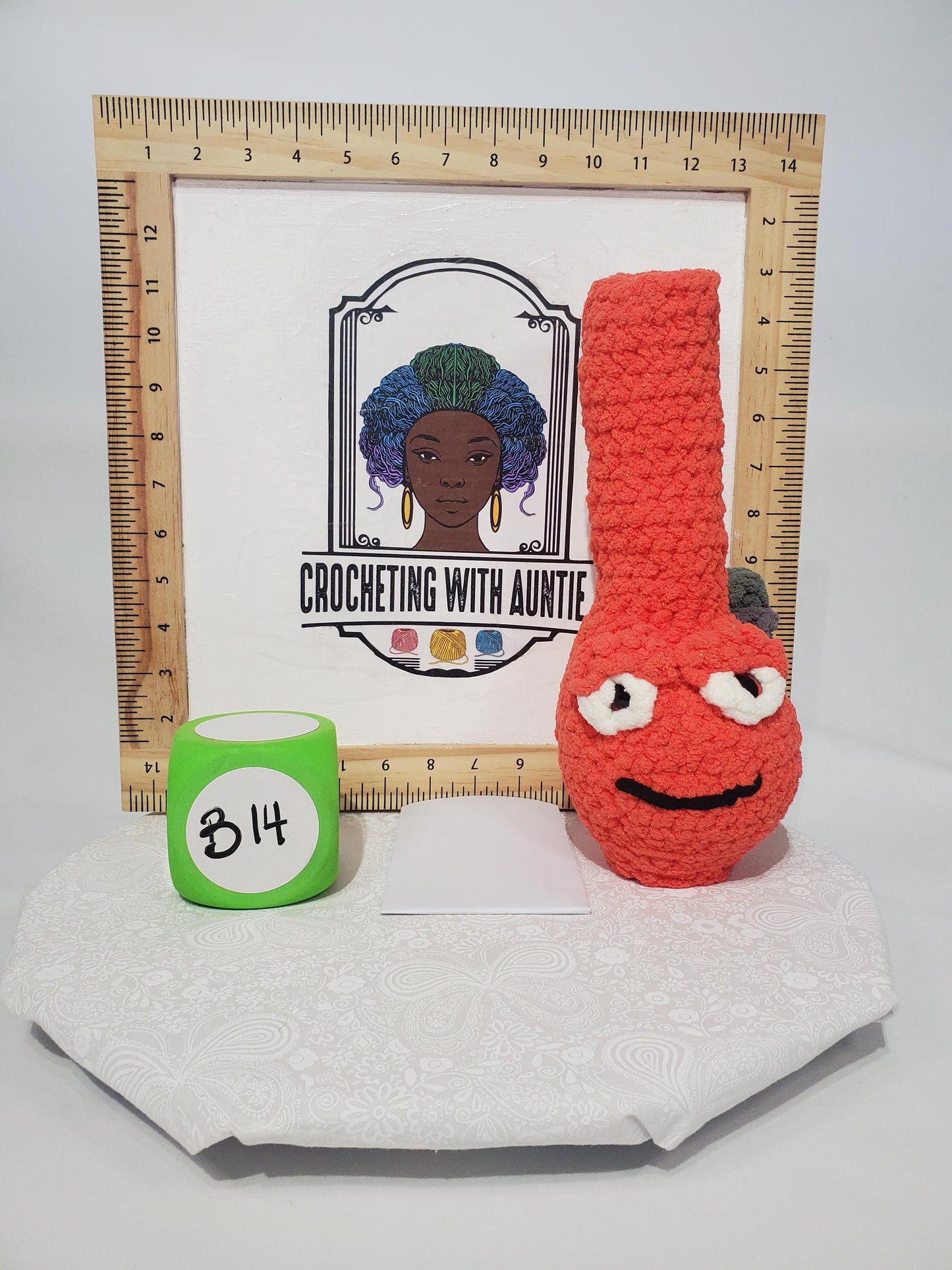 B14: Crochet Bong, Orange, made with 100% polyester, soft blanket yarn, and safety eyes, approx. 11" x 4", 6 oz