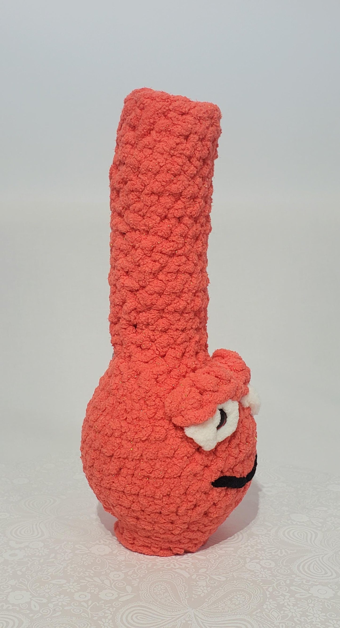 B14: Crochet Bong, Orange, made with 100% polyester, soft blanket yarn, and safety eyes, approx. 11" x 4", 6 oz